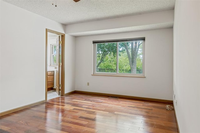 1101 Claycrest Dr, Cottleville Township, MO 63304 - unfurnished room featuring hardwood / wood-style floors, a textured ceiling, baseboards, and ceiling fan