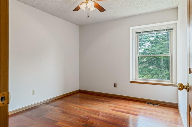 1101 Claycrest Dr, Cottleville Township, MO 63304 - empty room with wood finished floors, ceiling fan, a textured ceiling, and baseboards