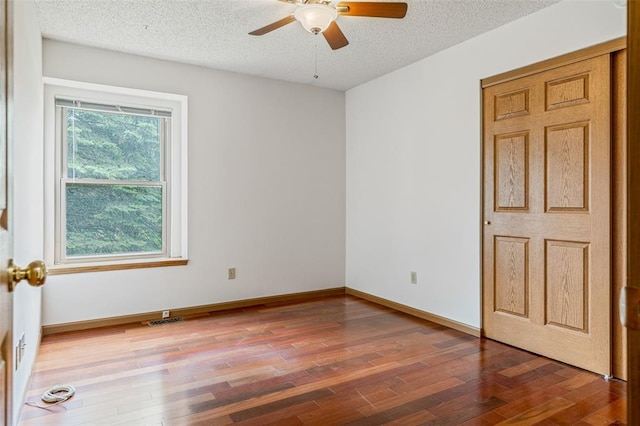 1101 Claycrest Dr, Cottleville Township, MO 63304 - spare room featuring a textured ceiling, wood finished floors, a ceiling fan, and baseboards
