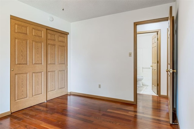 1101 Claycrest Dr, Cottleville Township, MO 63304 - unfurnished bedroom with hardwood / wood-style flooring, a closet, and baseboards