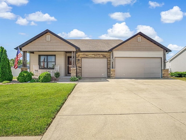 726 Pheasant Run, Waterloo, IL 62298 - view of front facade featuring an attached garage, a front lawn, driveway, covered porch, and stone siding