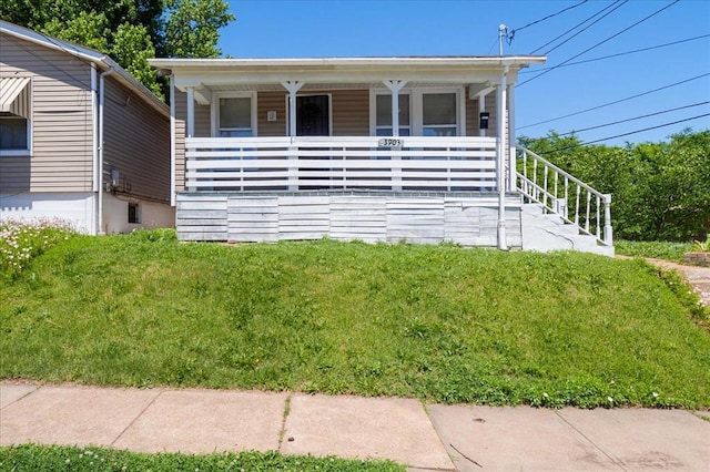 3903 Schiller Pl, Saint Louis, MO 63116 - view of front facade with covered porch and a front lawn