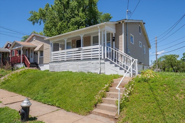 3903 Schiller Pl, Saint Louis, MO 63116 - view of front of property featuring covered porch, stairway, and a front lawn