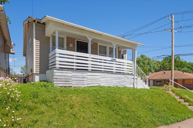 3903 Schiller Pl, Saint Louis, MO 63116 - view of front of property featuring covered porch, cooling unit, a front yard, and stairway