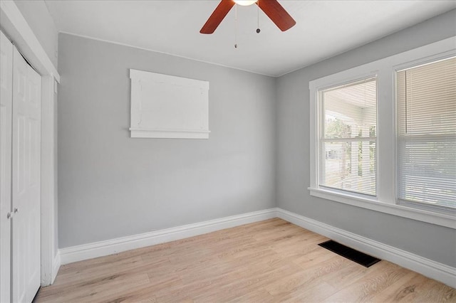 3903 Schiller Pl, Saint Louis, MO 63116 - unfurnished bedroom with light wood finished floors, a closet, baseboards, and a ceiling fan