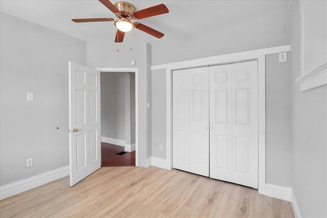 3903 Schiller Pl, Saint Louis, MO 63116 - unfurnished bedroom featuring light wood-style flooring, baseboards, a closet, and ceiling fan