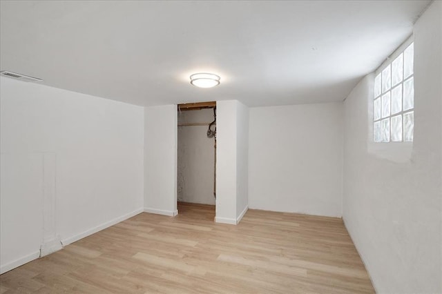 3903 Schiller Pl, Saint Louis, MO 63116 - unfurnished bedroom with wood finished floors, a closet, and baseboards
