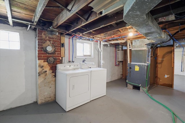 3903 Schiller Pl, Saint Louis, MO 63116 - basement with washing machine and dryer, heating unit, healthy amount of natural light, and water heater