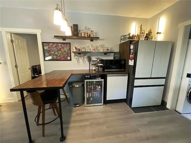 1509 Booker St, Hannibal, MO 63401 - indoor bar featuring freestanding refrigerator, wine cooler, dishwasher, washer / dryer, and light wood-type flooring