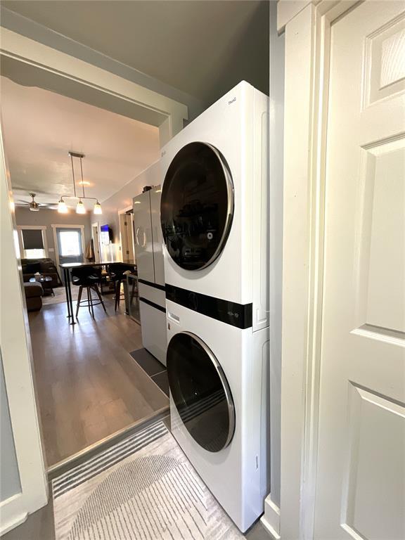 1509 Booker St, Hannibal, MO 63401 - laundry area with stacked washer / dryer and wood finished floors