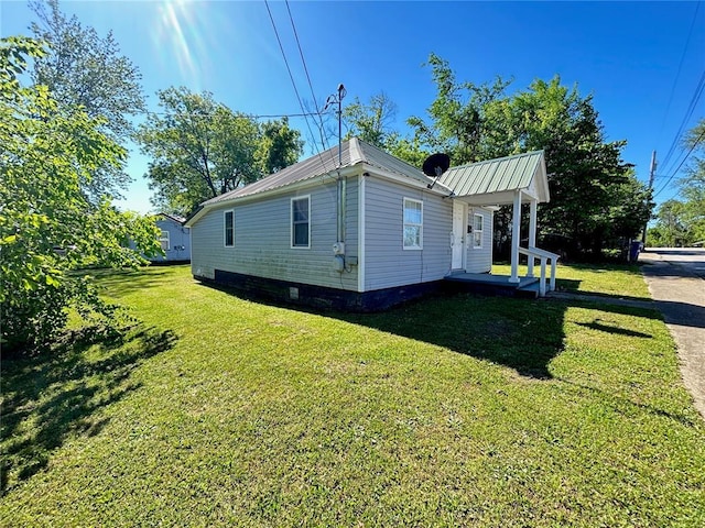 500 S Warfel St, Salem, MO 65560 - view of side of home with a yard, covered porch, and metal roof