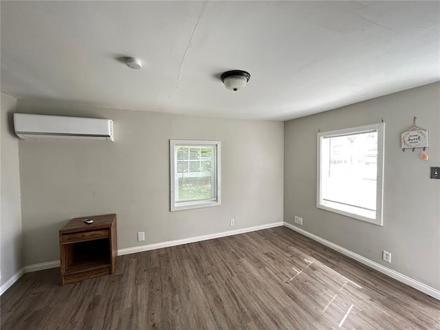 500 S Warfel St, Salem, MO 65560 - empty room with a wall mounted AC, wood finished floors, baseboards, and a smoke detector