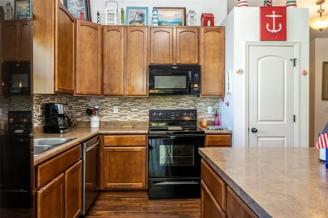 983 Fairway Dr, Union, MO 63084 - kitchen with black appliances, dark wood-type flooring, tasteful backsplash, and brown cabinets