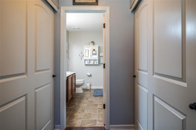 983 Fairway Dr, Union, MO 63084 - bathroom with baseboards, toilet, vanity, and stone finish floors