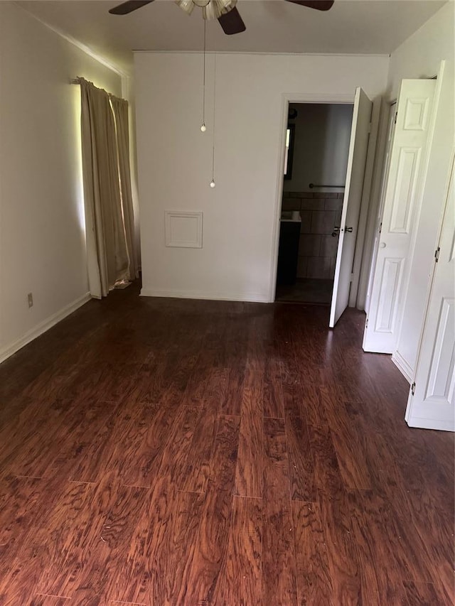 301 S Elm St, Malden, MO 63863 - spare room with ceiling fan, dark wood-style flooring, and baseboards