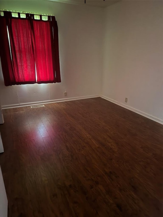 301 S Elm St, Malden, MO 63863 - spare room with dark wood-type flooring and baseboards