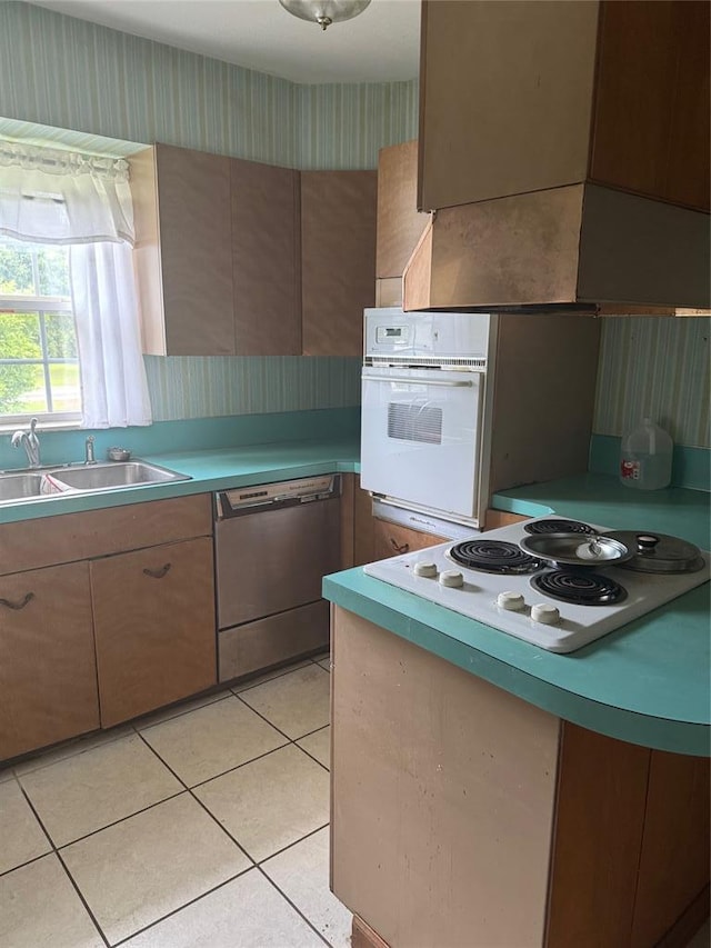 301 S Elm St, Malden, MO 63863 - kitchen with white appliances, wallpapered walls, a sink, light tile patterned floors, and light countertops