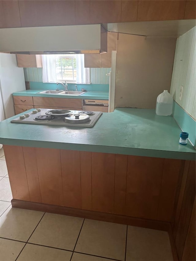 301 S Elm St, Malden, MO 63863 - kitchen with a sink, electric cooktop, light countertops, and light tile patterned floors