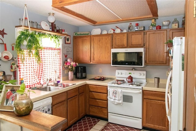 1001 Hemingway Ln Unit H, Weldon Spring, MO 63304 - kitchen featuring white appliances, a sink, brown cabinetry, and tile countertops