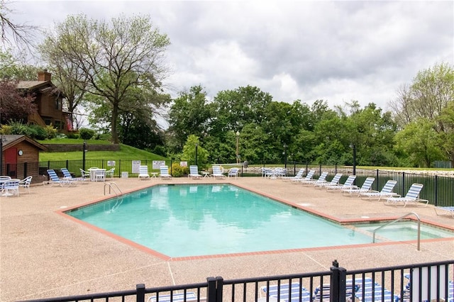 1001 Hemingway Ln Unit H, Weldon Spring, MO 63304 - community pool featuring a patio area, view of wooded area, and a hot tub