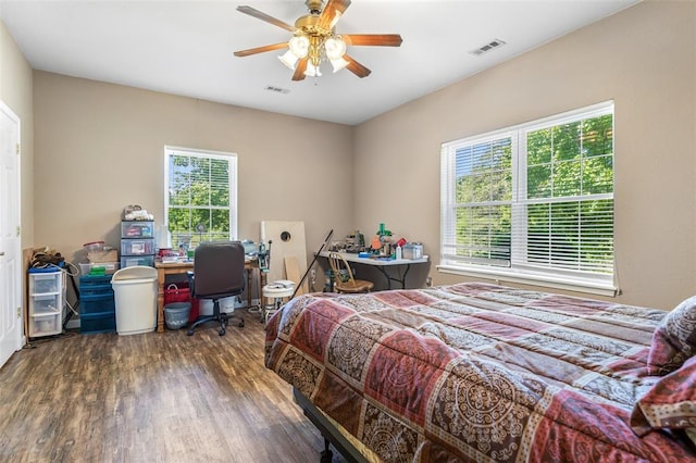 1308 Maggie Cir, Bonne Terre, MO 63628 - bedroom with wood finished floors, multiple windows, a desk, and a ceiling fan