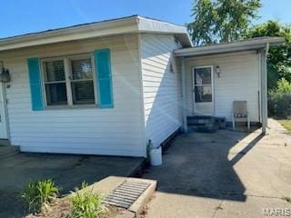 208 Edwards Ave, Sikeston, MO 63801 - view of home's exterior with entry steps and a patio area