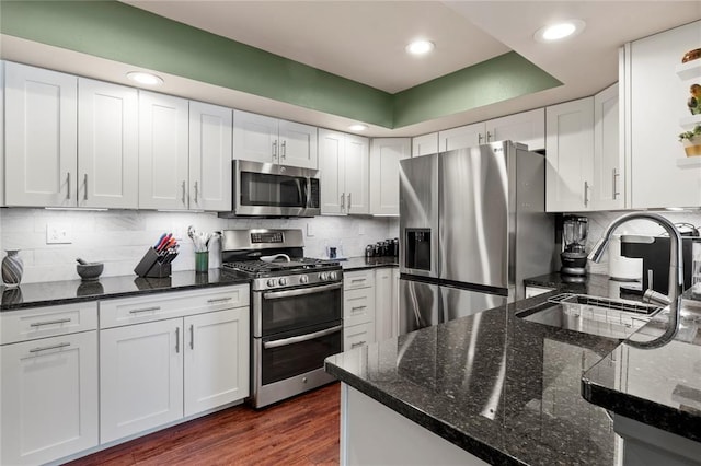 4501 Eli Dr I, Unit I, MO 63128 - kitchen with appliances with stainless steel finishes, a sink, white cabinetry, dark stone counters, and recessed lighting