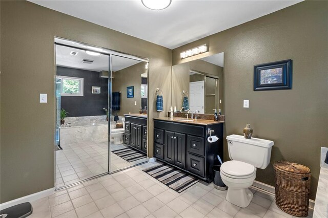 4501 Eli Dr I, Unit I, MO 63128 - bathroom featuring vanity, a bath, toilet, tile patterned floors, and baseboards