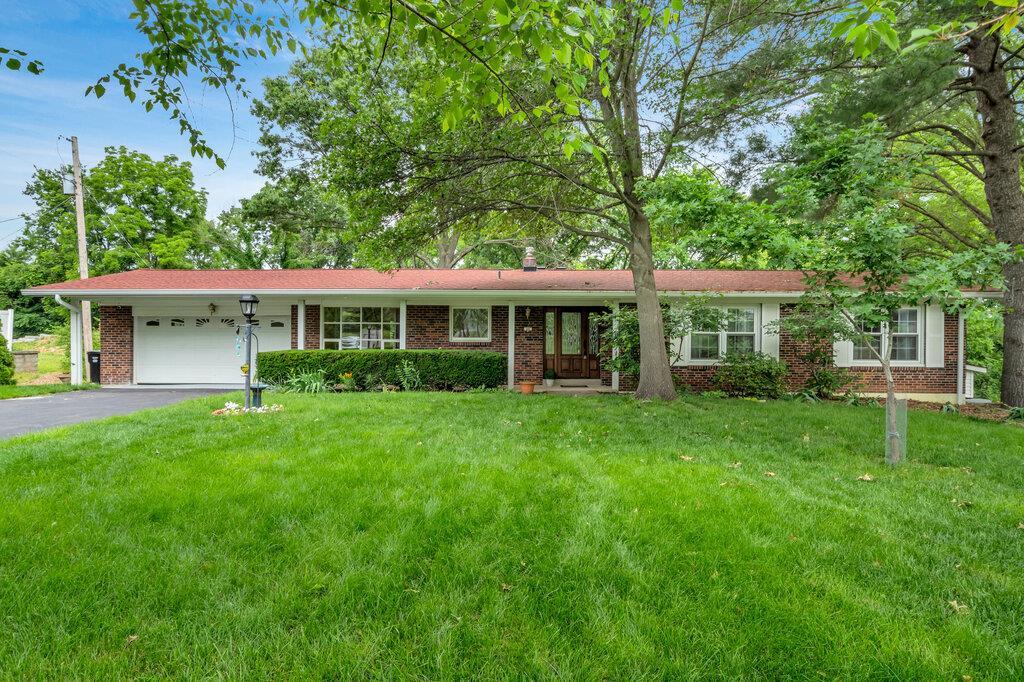 49 Rae Ct, Saint Louis, MO 63146 - ranch-style house featuring an attached garage, driveway, brick siding, and a front yard