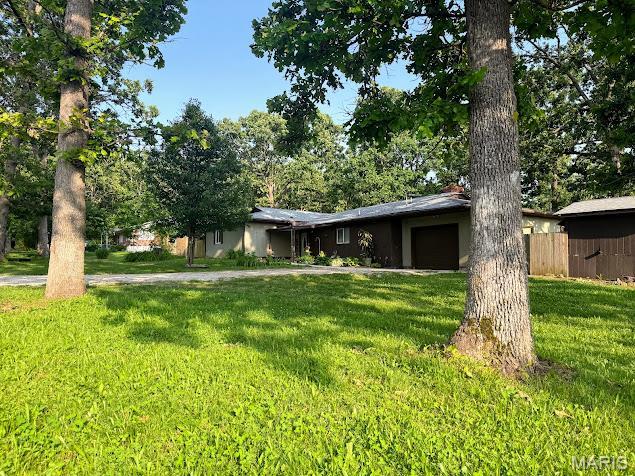 11230 W Little Oaks Rd, Rolla, MO 65401 - view of front of home featuring an attached garage and stucco siding