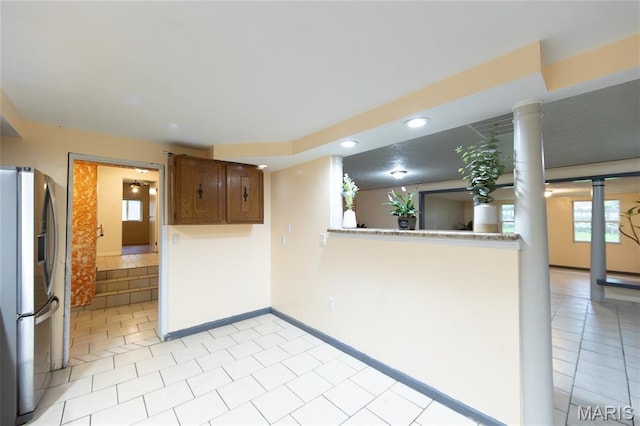 11230 W Little Oaks Rd, Rolla, MO 65401 - kitchen featuring stainless steel fridge with ice dispenser, recessed lighting, plenty of natural light, ornate columns, and light tile patterned flooring