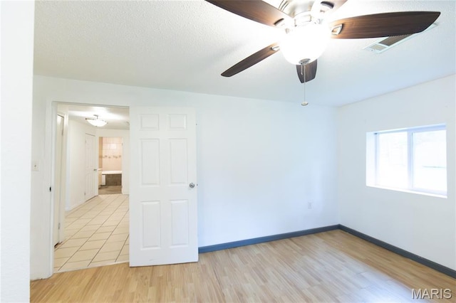 11230 W Little Oaks Rd, Rolla, MO 65401 - empty room featuring a ceiling fan, light wood finished floors, and baseboards