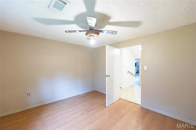 11230 W Little Oaks Rd, Rolla, MO 65401 - spare room with ceiling fan, light wood finished floors, a textured ceiling, and baseboards