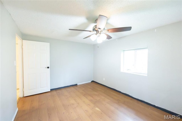 11230 W Little Oaks Rd, Rolla, MO 65401 - unfurnished room featuring ceiling fan, light wood-style floors, baseboards, and a textured ceiling