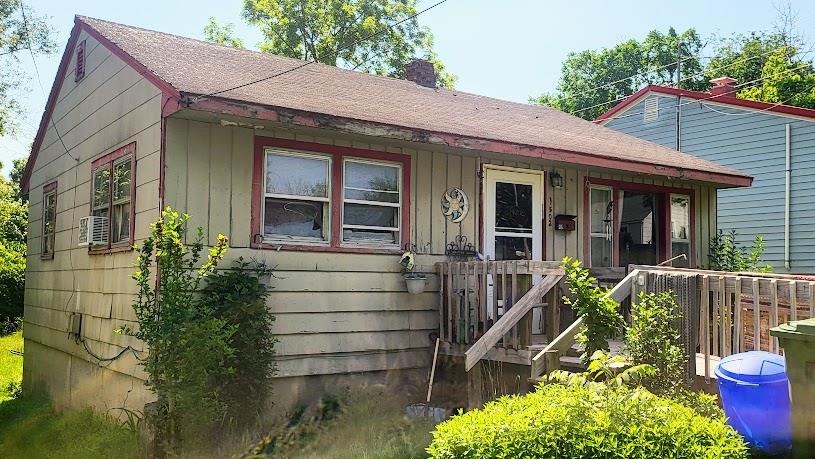 1502 Martin St, Rolla, MO 65401 - bungalow-style home featuring a chimney, roof with shingles, covered porch, and board and batten siding