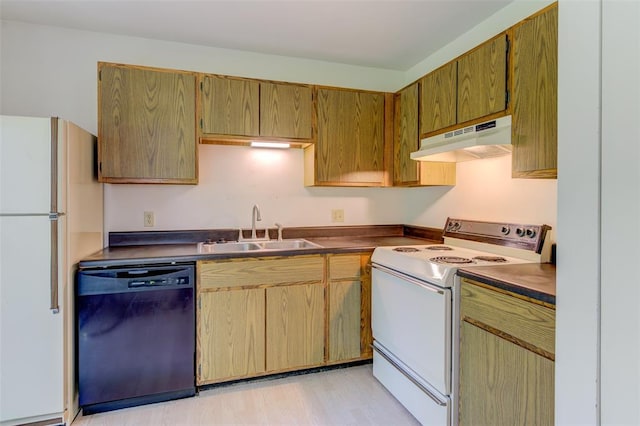 717 Sugar Glen Dr Unit 1, Saint Peters, MO 63376 - kitchen featuring white appliances, under cabinet range hood, a sink, dark countertops, and light wood-style floors