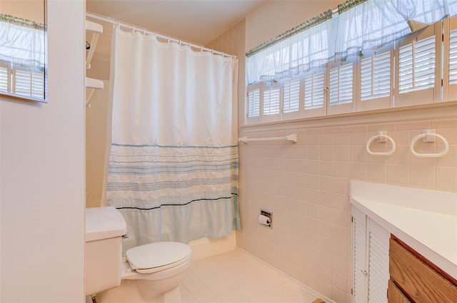 717 Sugar Glen Dr Unit 1, Saint Peters, MO 63376 - bathroom featuring toilet, tile patterned floors, a shower with curtain, vanity, and tile walls
