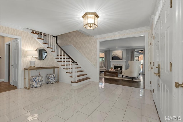 50 Lake Forest Dr, Richmond Heights, MO 63117 - entrance foyer featuring stairway, a fireplace, ornamental molding, marble finish floors, and wallpapered walls