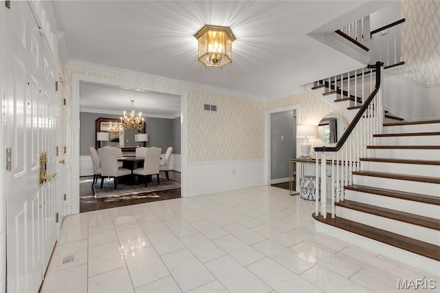 50 Lake Forest Dr, Richmond Heights, MO 63117 - foyer with a chandelier, stairway, crown molding, a wainscoted wall, and marble finish flooring