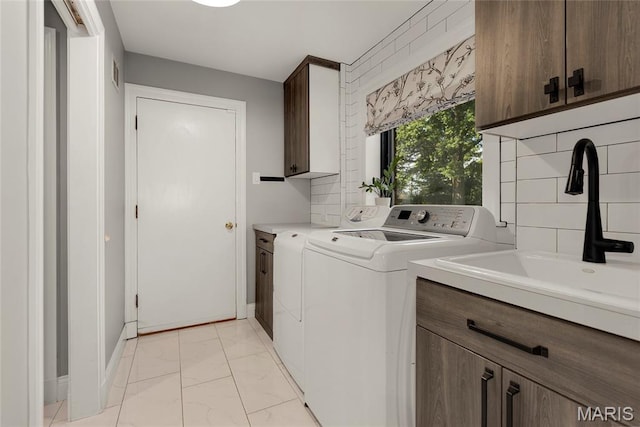 50 Lake Forest Dr, Richmond Heights, MO 63117 - laundry area with cabinet space, independent washer and dryer, light marble finish flooring, and baseboards