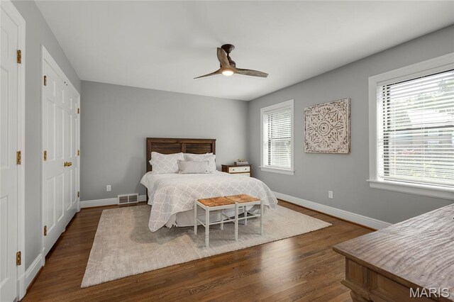 50 Lake Forest Dr, Richmond Heights, MO 63117 - bedroom with dark wood-style floors, multiple windows, and baseboards