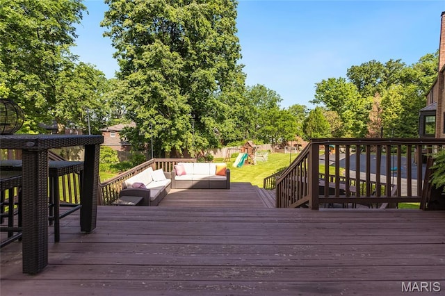 50 Lake Forest Dr, Richmond Heights, MO 63117 - wooden deck featuring an outdoor hangout area, a playground, and a lawn