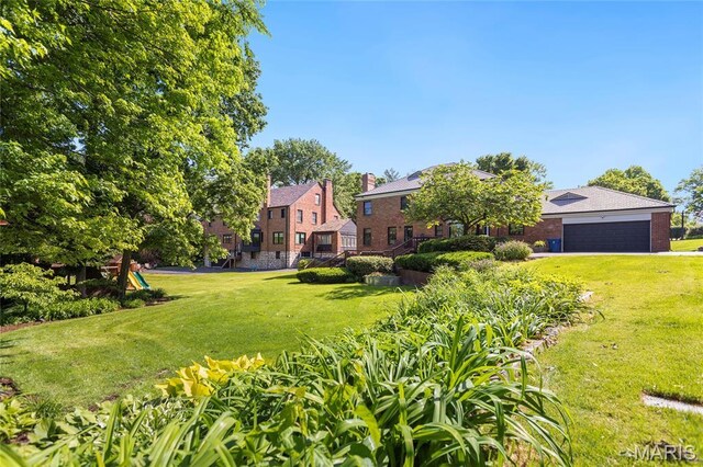 50 Lake Forest Dr, Richmond Heights, MO 63117 - view of green lawn with an attached garage