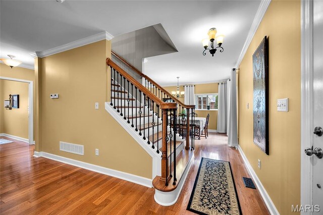 2785 Marble Springs Rd, Barnhart, MO 63012 - entrance foyer featuring a chandelier, crown molding, light wood-type flooring, baseboards, and stairway
