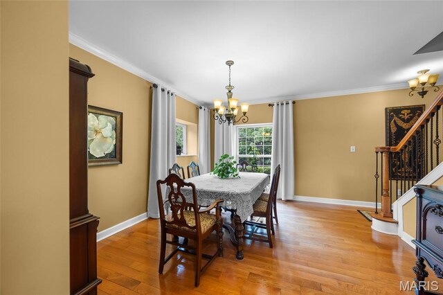 2785 Marble Springs Rd, Barnhart, MO 63012 - dining space featuring a chandelier, stairway, crown molding, light wood-style flooring, and baseboards