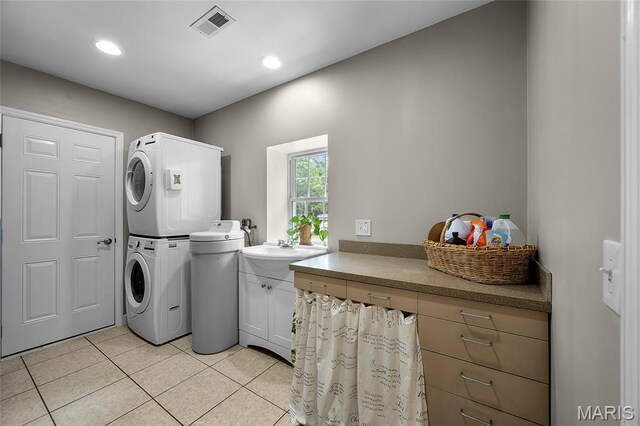 2785 Marble Springs Rd, Barnhart, MO 63012 - laundry area featuring estacked washer and dryer, cabinet space, light tile patterned floors, and recessed lighting