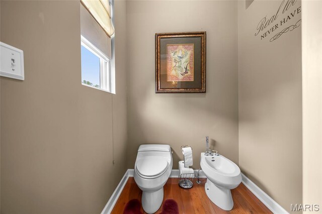 2785 Marble Springs Rd, Barnhart, MO 63012 - half bath with a bidet, toilet, wood finished floors, and baseboards