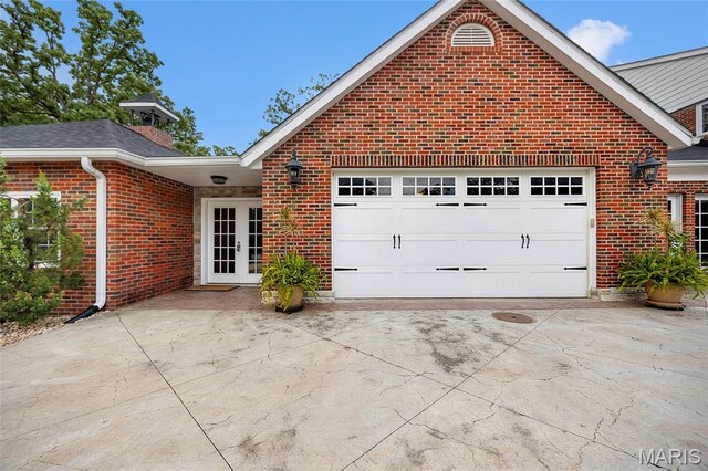 2785 Marble Springs Rd, Barnhart, MO 63012 - view of side of home featuring french doors, concrete driveway, a garage, and brick siding