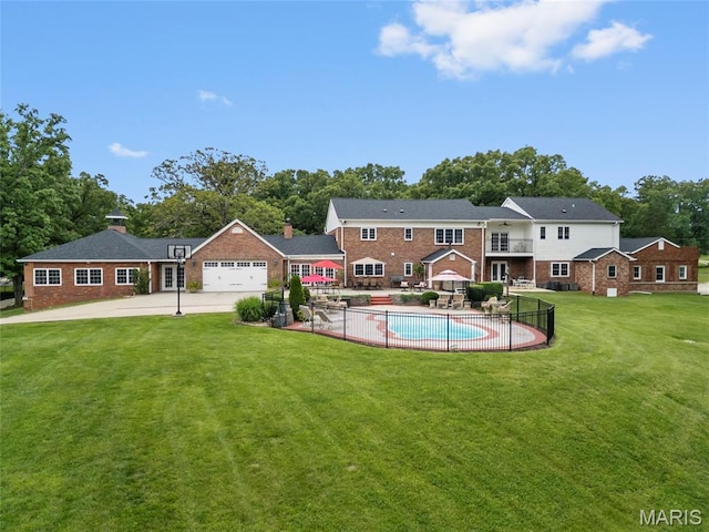 2785 Marble Springs Rd, Barnhart, MO 63012 - back of house with brick siding, driveway, an attached garage, and a patio