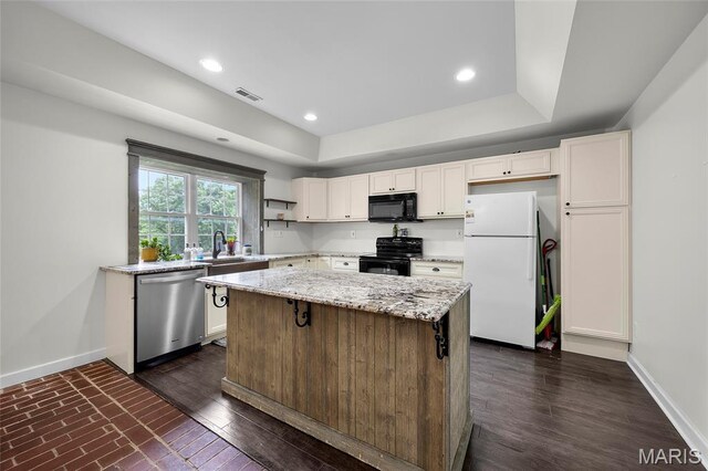2785 Marble Springs Rd, Barnhart, MO 63012 - kitchen featuring black appliances, baseboards, a kitchen island, white cabinets, and light stone counters